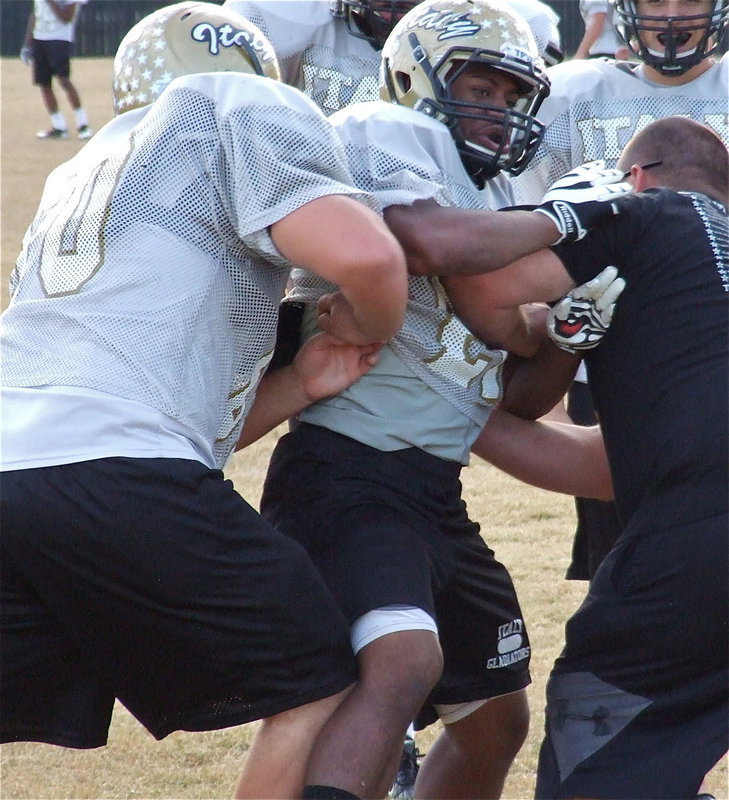 Image: Defensive lineman Jalarnce Lewis practices winning the gap against teammate Kevin Roldan and line coach Brandon Duncan. Italy takes on the Honey Grove Warriors in Wills Point starting at 7:30 p.m. on Friday, November 30, 2012 for the regional championship.