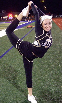 Image: Gladiator cheerleader Britney Chambers gets stretched for the second half kickoff. Britney’s “scorpion” move was apropos as the Gladiator defense kept stinging the Warriors with one big hit after another.