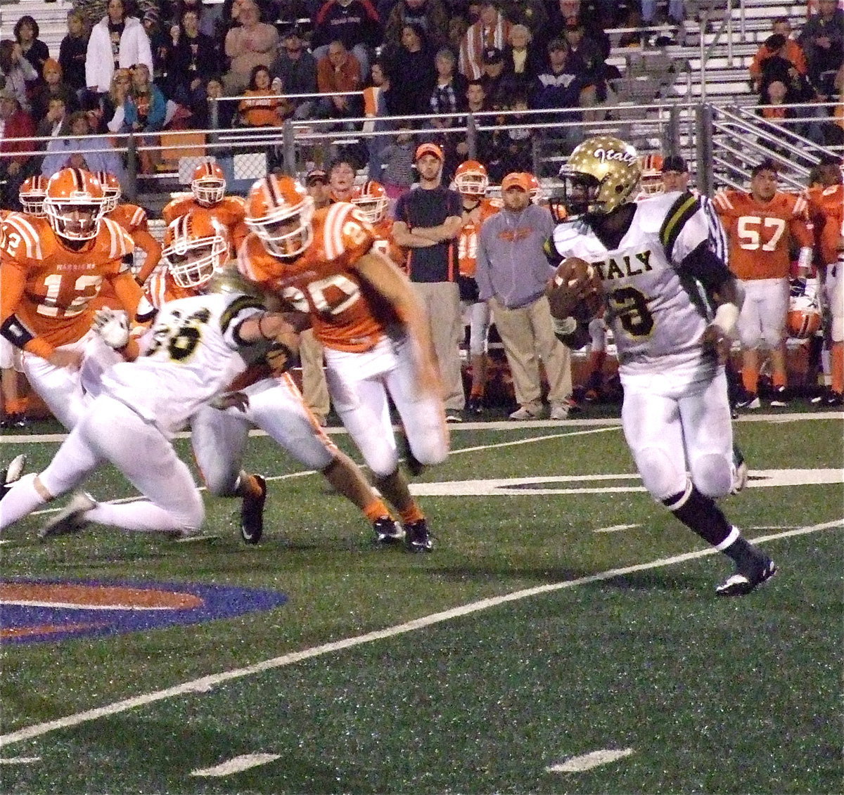 Image: Center Kyle Fortenberry(66) picks off Warrior defenders as quarterback Marvin Cox(3) looks for running room. Cox finished the night with 238 rushing yards on 16 carries, completed 1-of-3 passes for 14-yards and totaled 4 touchdowns.