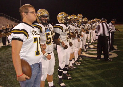 Image: Colin Newman(76), Zain Byers(50) and Marvin Cox(3) support their captains during the coin toss.