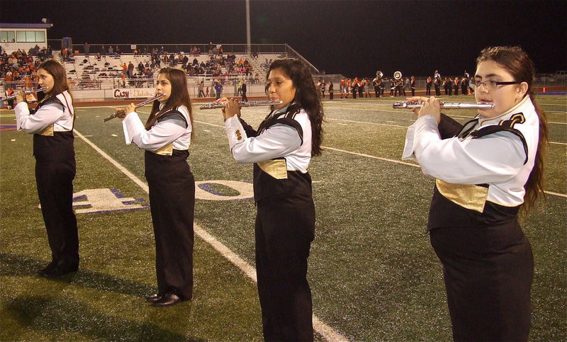 Image: Gladiator Regiment Band members Whitney Wolaver, Haley Benavidez, Julissa Hernandez and Morgan Junkin play their flutes during halftime.