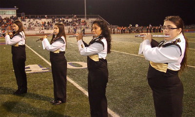 Image: Gladiator Regiment Band members Whitney Wolaver, Haley Benavidez, Julissa Hernandez and Morgan Junkin play their flutes during halftime.