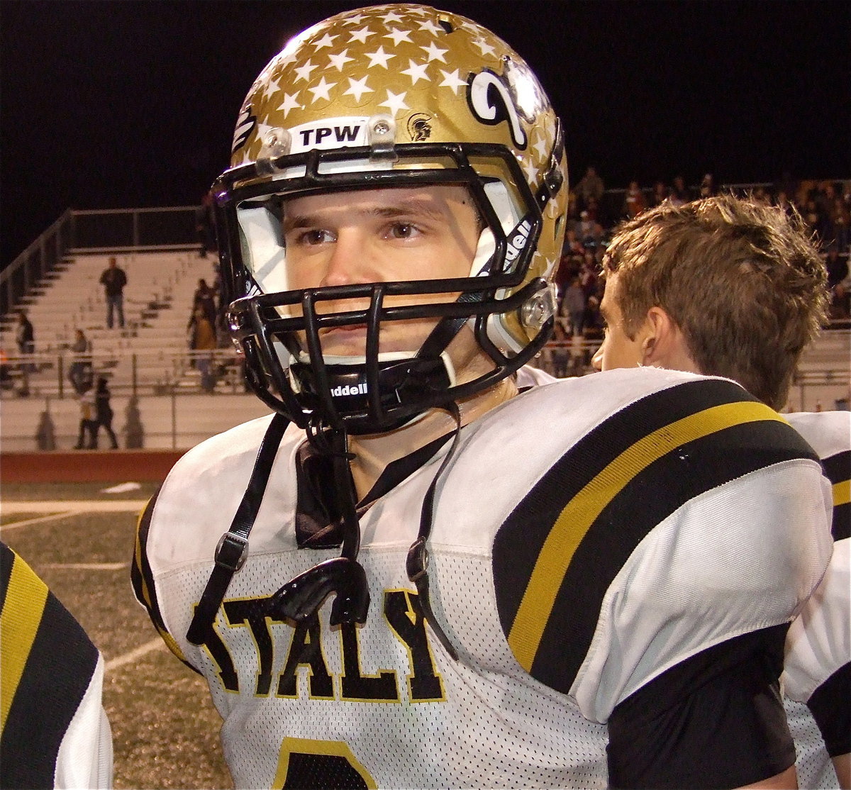 Image: Senior hitman Chase Hamilton(2) respects Honey Grove’s playing of this school song after Italy’s 33-20 win.