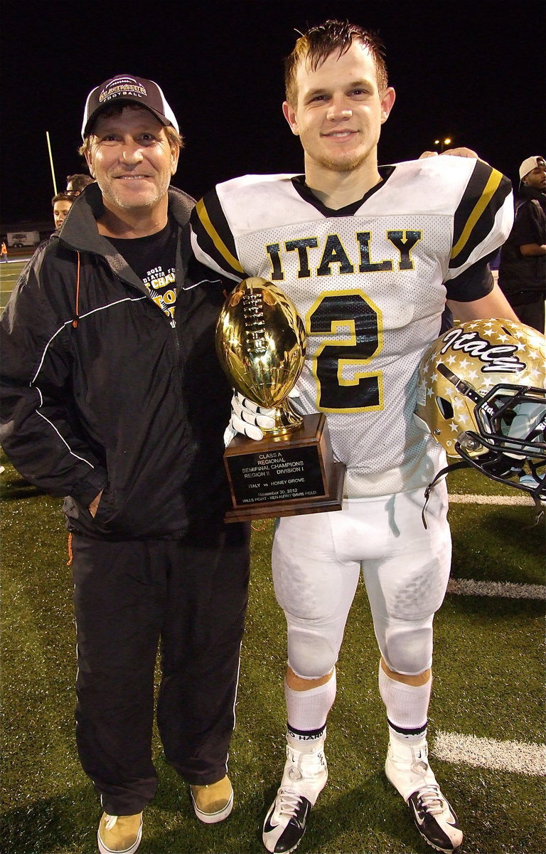 Image: Proud pop: Lee Hamilton with his son, Chase Hamilton(2), as they pose with the regional semifinal championship trophy.