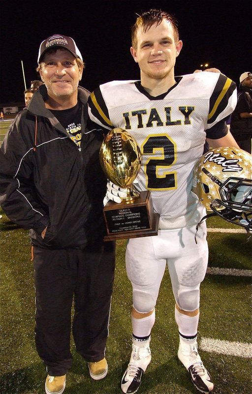 Image: Proud pop: Lee Hamilton with his son, Chase Hamilton(2), as they pose with the regional semifinal championship trophy.