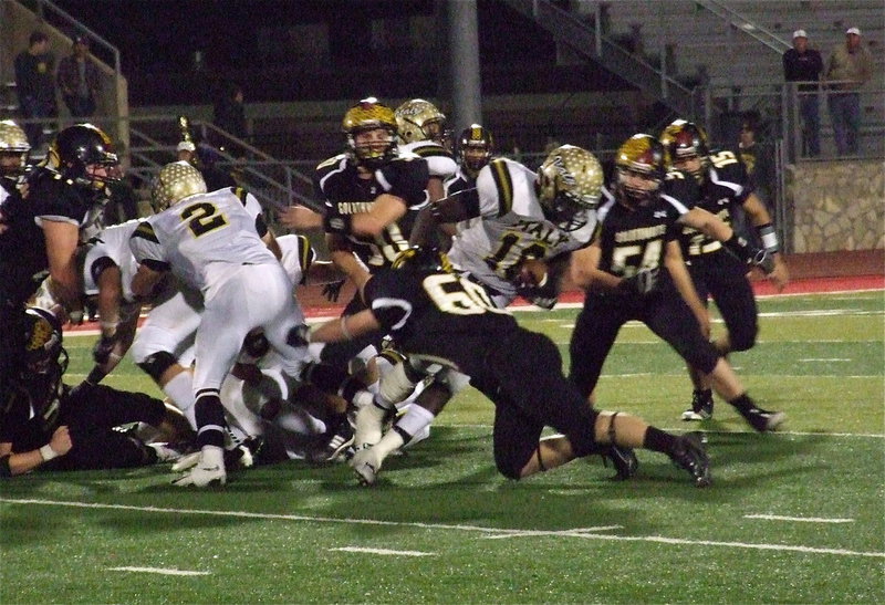 Image: Italy’s Zackery Boykin(55) and Chase Hamilton(2) create a gap for Ryheem Walker(10) who fights for as many yards as he can get.