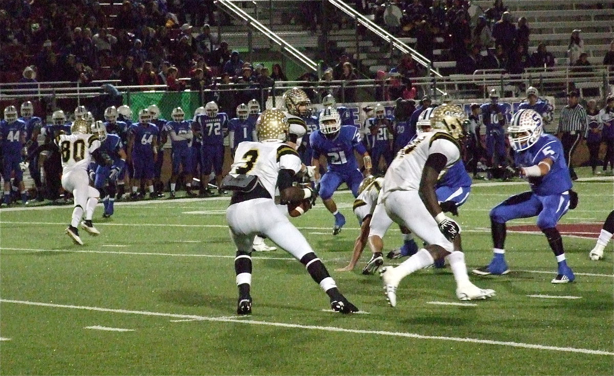 Image: Quarterback Marvin Cox(3) drops back to pass, Kelvin Joffre(80) and Chase Hamilton(2) release downfield and Ryheem Walker(10) readies to block.