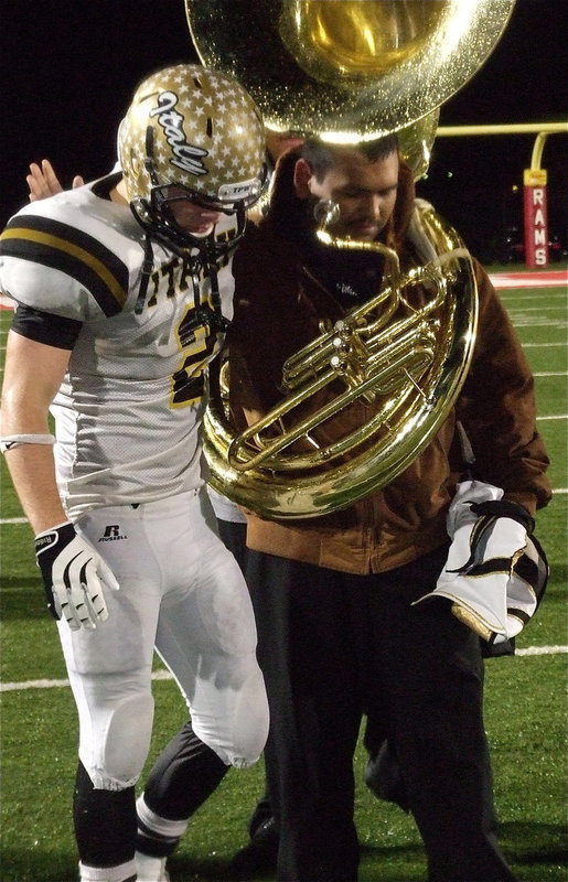 Image: Gladiator Senior Chase Hamilton(2) gets comforted by senior tuba player Jonathan Davila after Italy’s state semifinal 41-8 loss to Stamford.