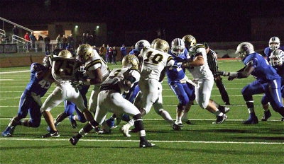 Image: Ryheem Walker(10) takes the handoff from Marvin Cox(3) and then tries punching thru the middle as Cody Medrano(75), Darol Mayberry(58) and Kevin Roldan(60) clear some room.