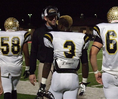 Image: Offensive coordinator Nate Skelton plans the next possession with quarterback Marvin Cox(3).