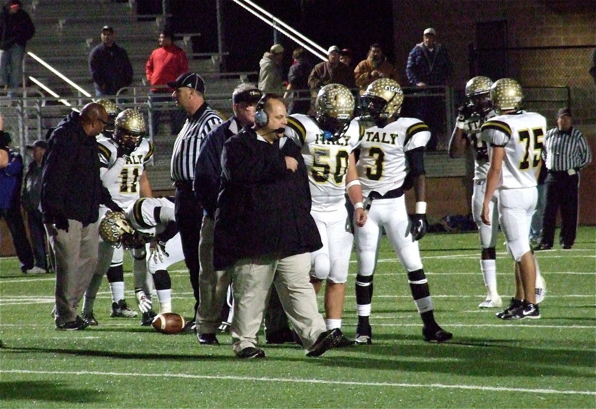 Image: After colliding with teammate Jalarnce Lewis(21) who is being checked on by assistant coach Larry Mayberry, Sr., Zain Byers(50) is escorted off the field by assistant coach Brian Coffman. Byers would later return and finish strong.