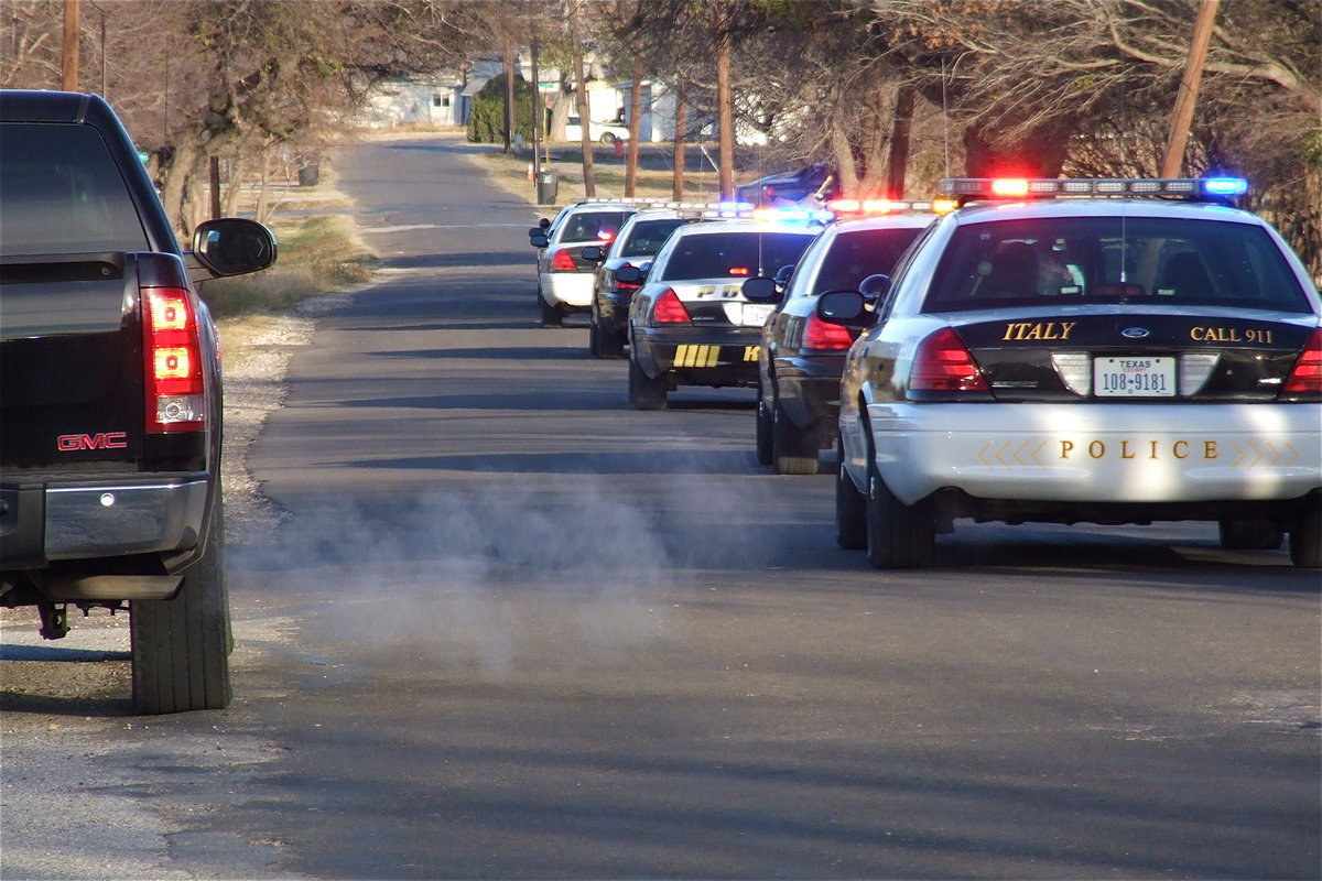 Image: Cars make way for the Italy Police Department sirens as Stafford’s students make a loud departure.