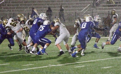 Image: Kevin Roldan(60), Zackery Boykin(55), Kyle Fortenberry(66), Zain Byers(50) and Ryheem Walker(10) keep battling in the downpour.