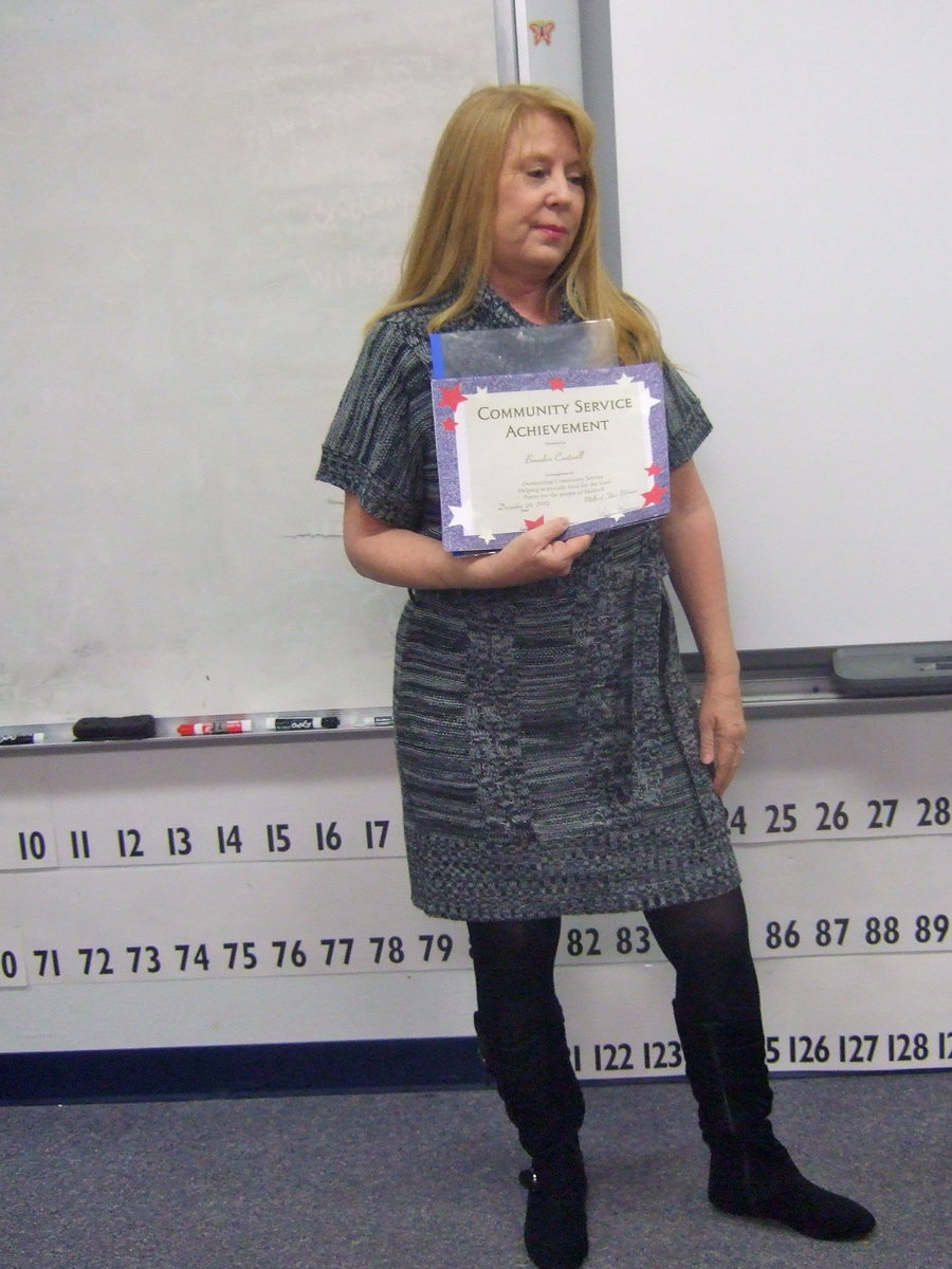 Image: Jeannie Richardson shows the class their community service award they received and told them how proud she was of them.