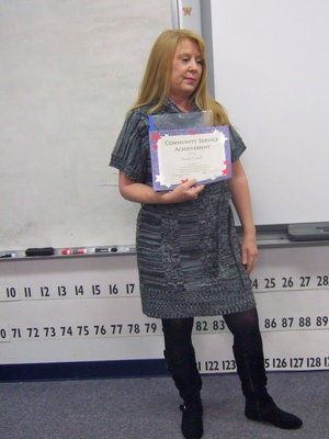 Image: Jeannie Richardson shows the class their community service award they received and told them how proud she was of them.