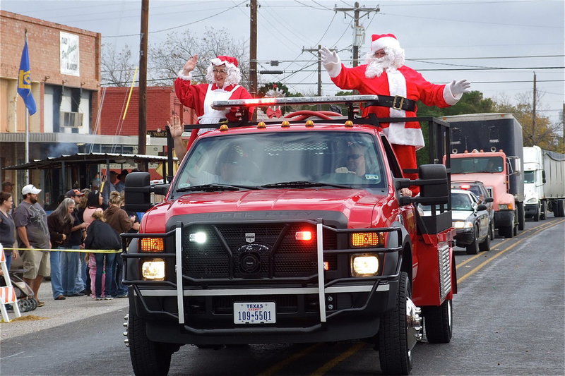 Image: Italy firefighters Jackie Cate and driver Michael Chambers serve as reindeer for Mr. and Mrs. Claus, with Donald and Karen Brummett in costume.