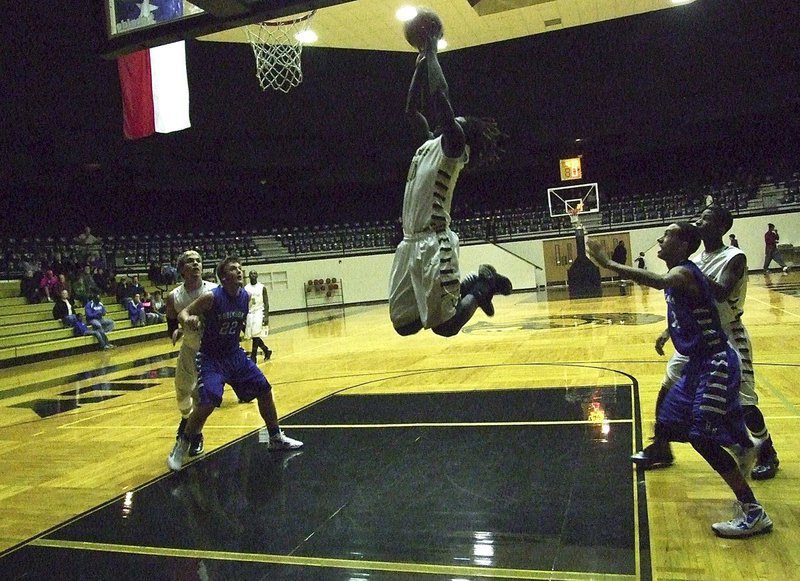 Image: Gladiator Ryheem Walker(10) sails in for the offensive rebound and the put back for 2-points but victory would ultimately belong to Waco Robinson who won both the varsity boys matchup, 52-26, and the JV boys matchup as well.