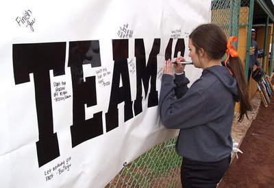 Image: Senior Morgan Cokerham jots down her goal for the season opener.