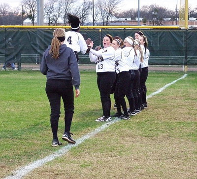 Image: K’Breona Davis is really excited for the 2013 season as teammates lineup to slap hands with Davis.