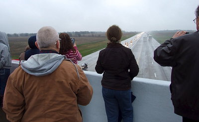 Image: Local citizens and veterans congregate along the Dale Acres overpass to show respect for for Chris Kyle as the funeral procession passes beneath them.