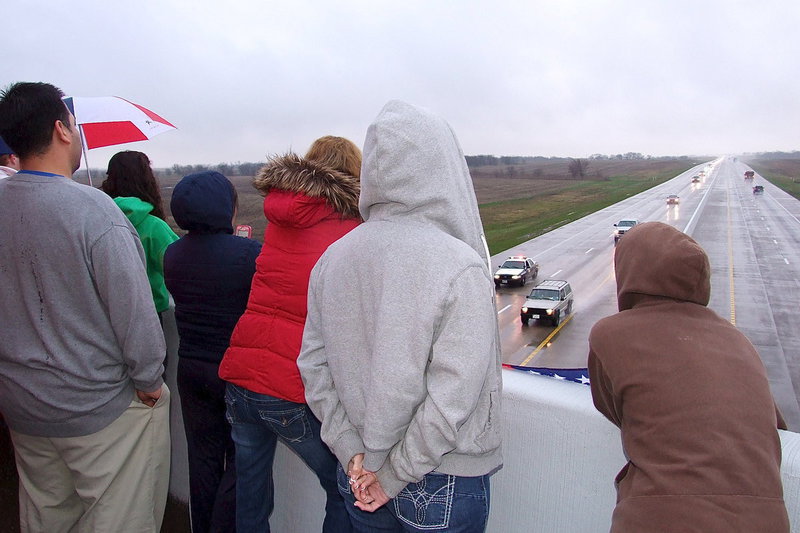 Image: The procession continues as the enormity of the moment begins to soak in for onlookers.