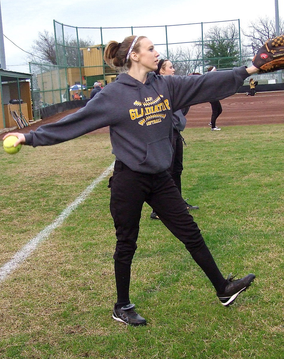 Image: Senior Lady Gladiator Brooke Miller winds up during warmups.