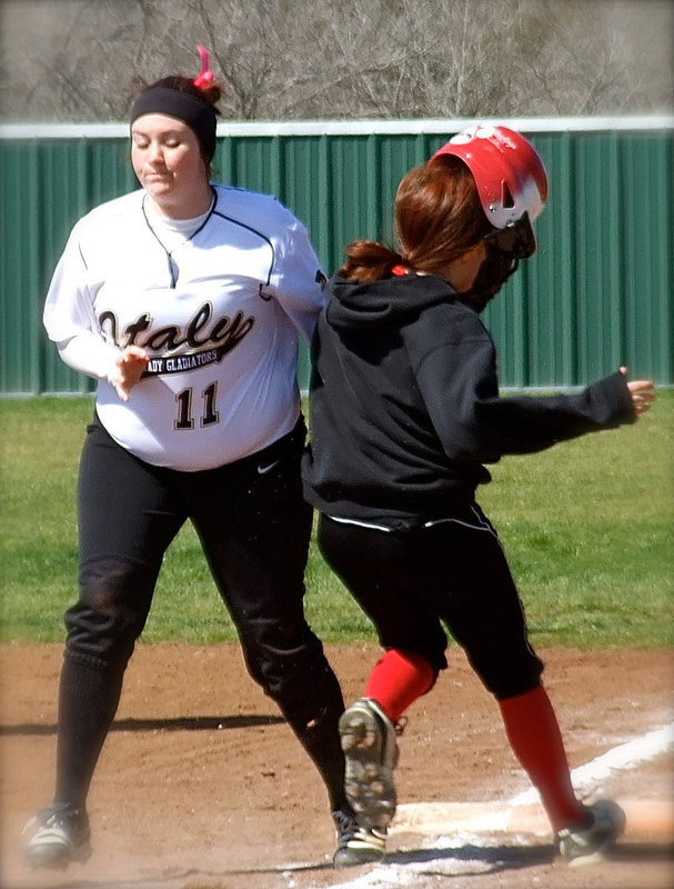 Image: Italy’s Breyanna Beets(11) gives a Terrell base runner a shoulder to crown as the two collide at first-base.