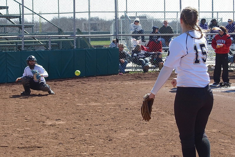 Image: Italy’s catcher Alyssa Richards(9) warms up pitcher Jaclynn Lewis(15).