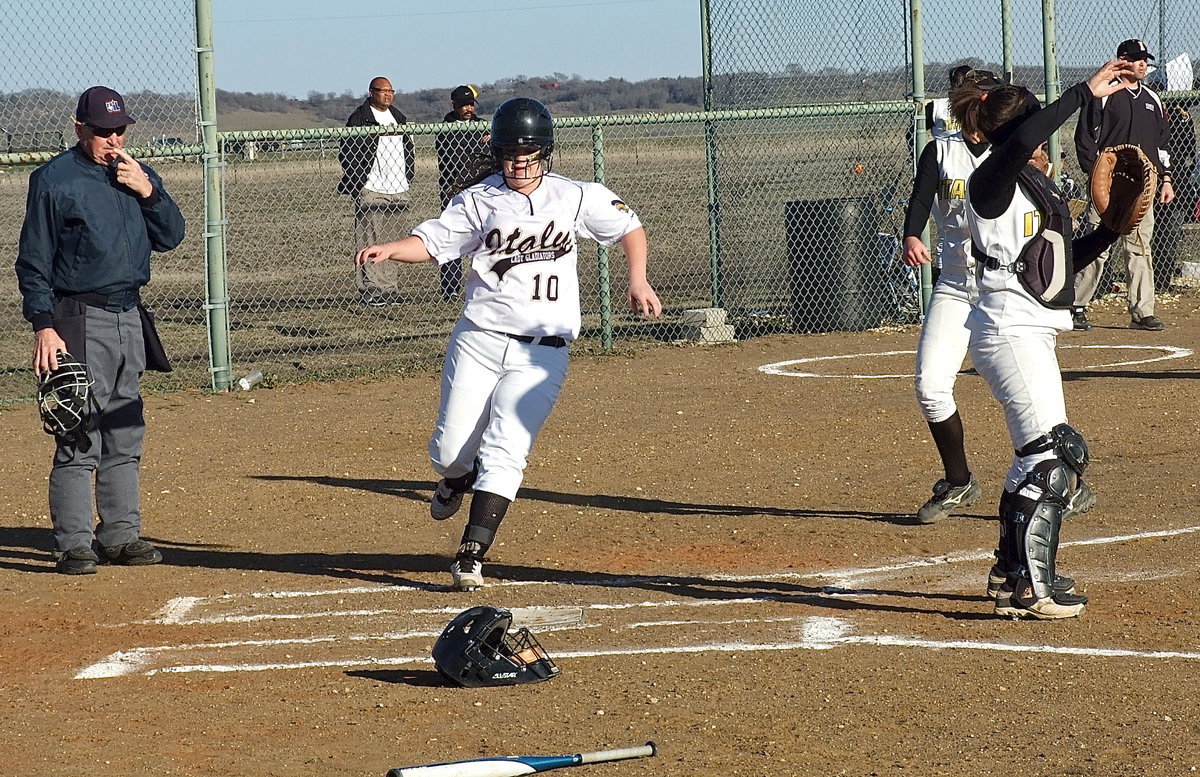 Image: Page Westbrook(10) finds home plate and taps it twice for good measure.