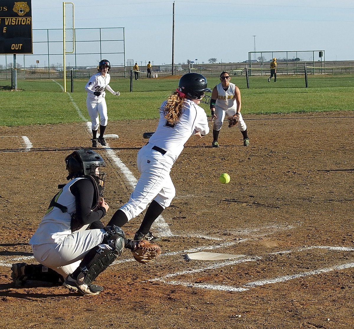 Image: Madison Washington(2) attempts to hit Kelsy Neslon(4) home from third for Italy.