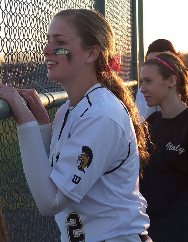 Image: Madison Washington(2) and Brooke Miller cheer on Italy’s batters from the dugout.