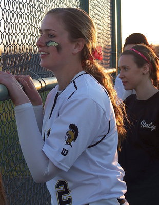 Image: Madison Washington(2) and Brooke Miller cheer on Italy’s batters from the dugout.