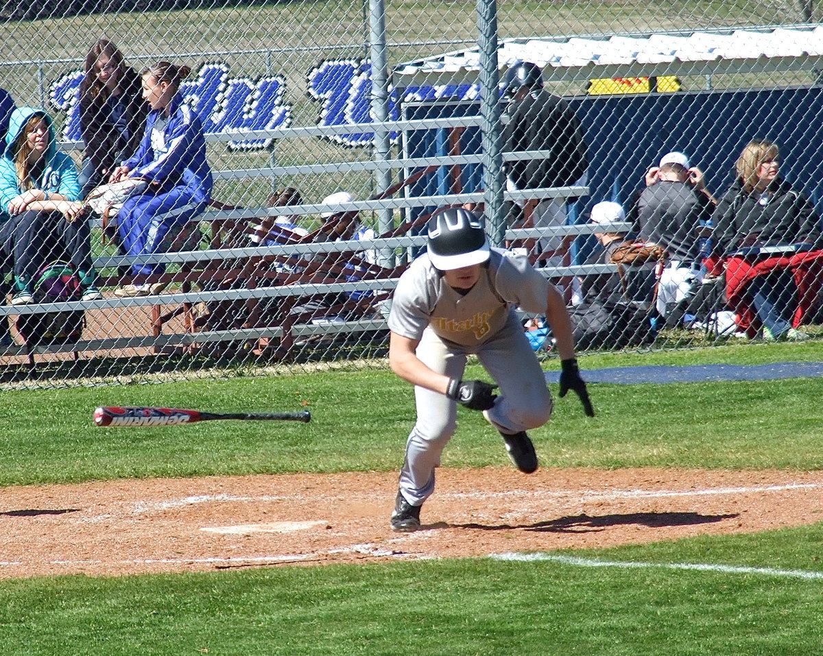 Image: Italy’s Hayden Woods(8) keeps his footing for a base hit.