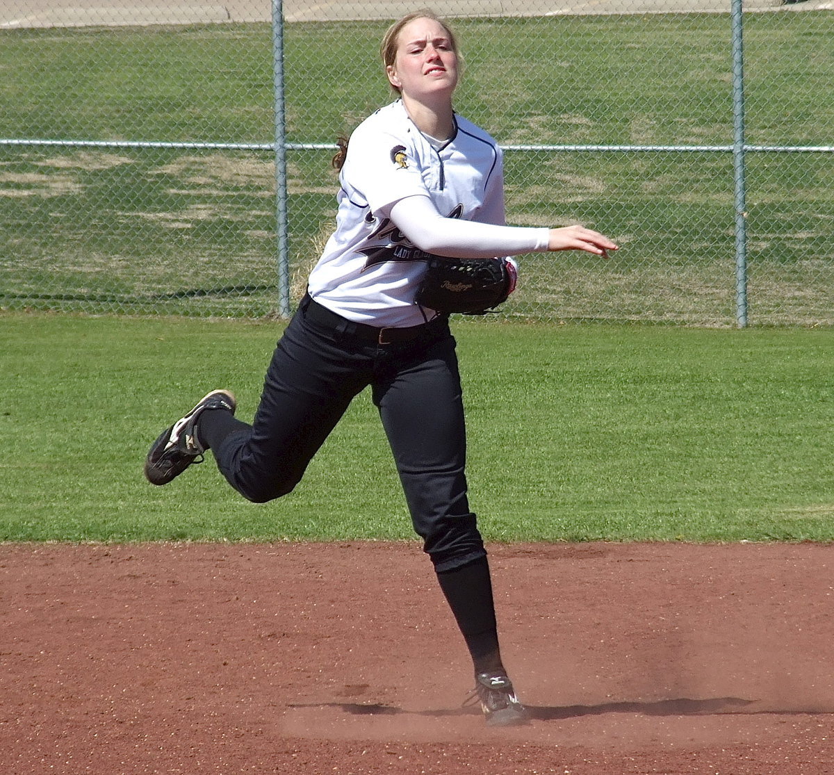 Image: Shortstop Madison Washington fires the ball to first base.