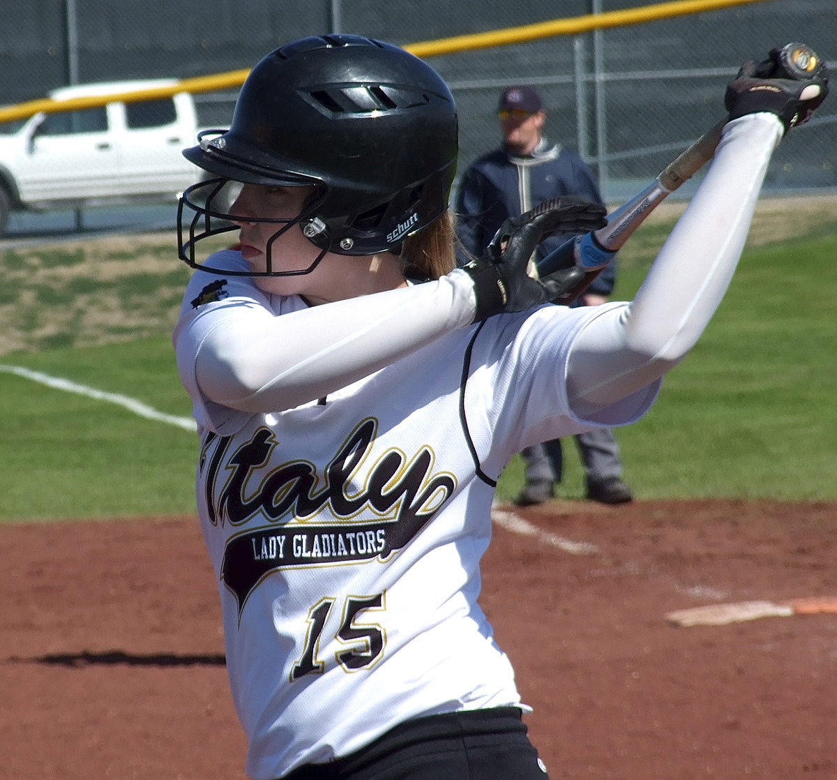 Image: Jaclynn Lewis gets stretched before stepping into the batter’s box.