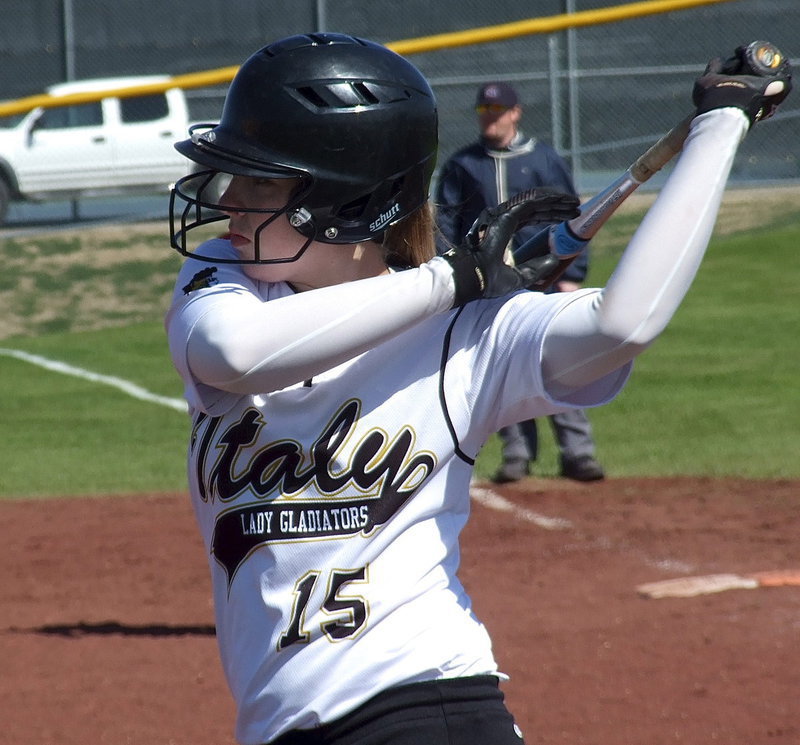 Image: Jaclynn Lewis gets stretched before stepping into the batter’s box.