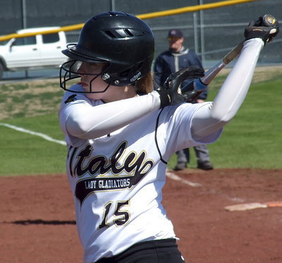 Image: Jaclynn Lewis gets stretched before stepping into the batter’s box.