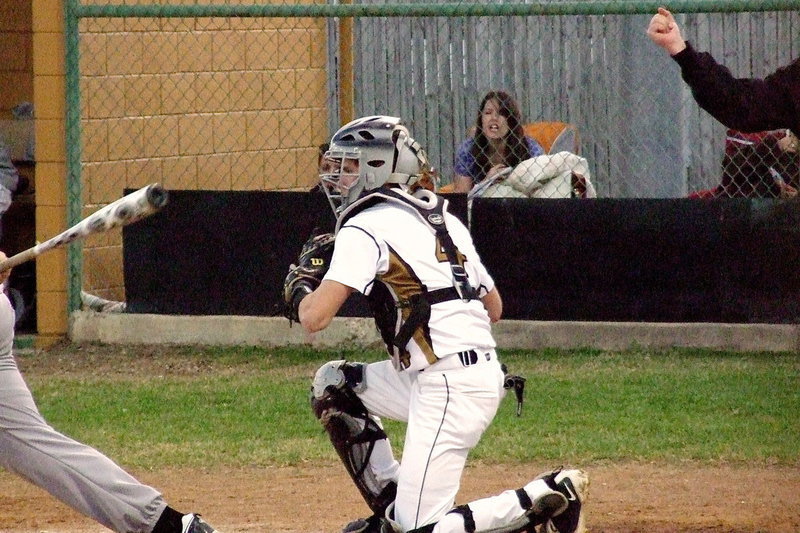 Image: Gladiator catcher Justin Wood(4) hauls in a strike-three pitch to the delight of Jessica Ward who is keeping the game book for Italy.