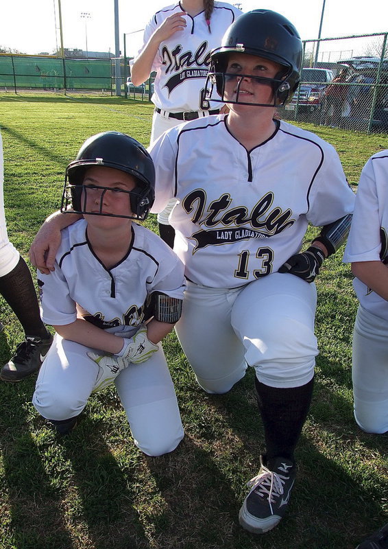 Image: Senior Katie Byers(13) and sophomore Tara Wallis(5) display unity during the post-game speech from head coach Brian Coffman.