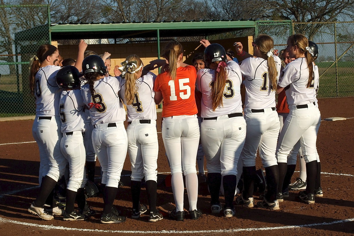 Image: Avalon’s Stephanie Gray and her Lady Eagle teammates join Italy in post-game prayer followed by a brief cheer.