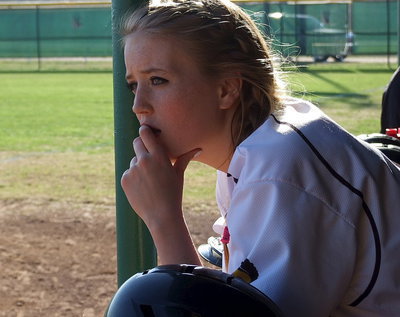 Image: Hannah Washington(6) studies Avalon’s lineup from the Italy dugout.