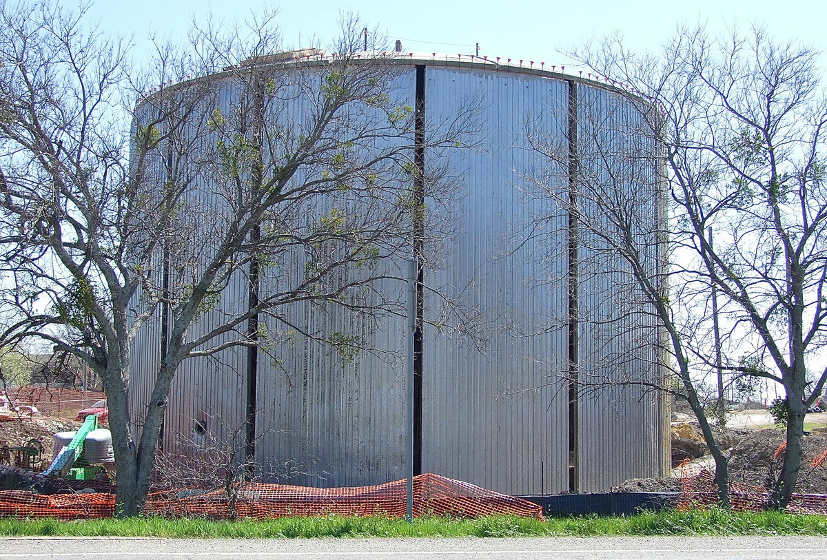 Image: The new concrete water tank with a dome top begins to take shape and stands behind the Harris Paint and Body Shop.