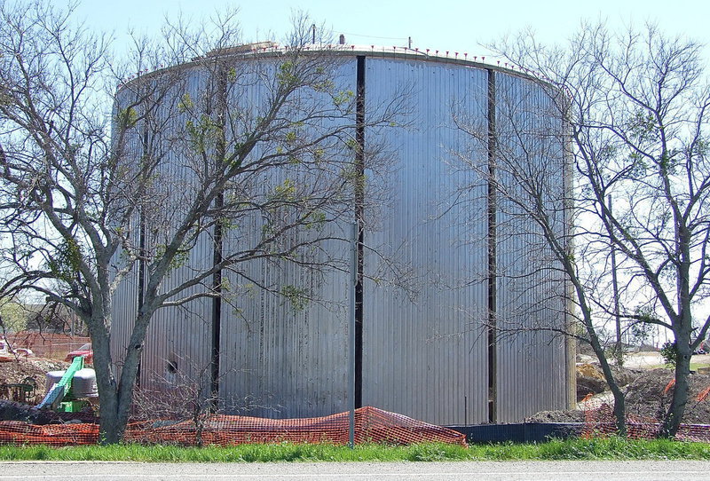 Image: The new concrete water tank with a dome top begins to take shape and stands behind the Harris Paint and Body Shop.