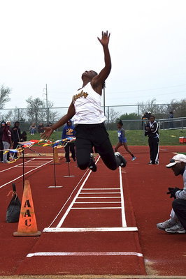 Image: Italy’s Kortnei Johnson reaches for the gold in the long jump.