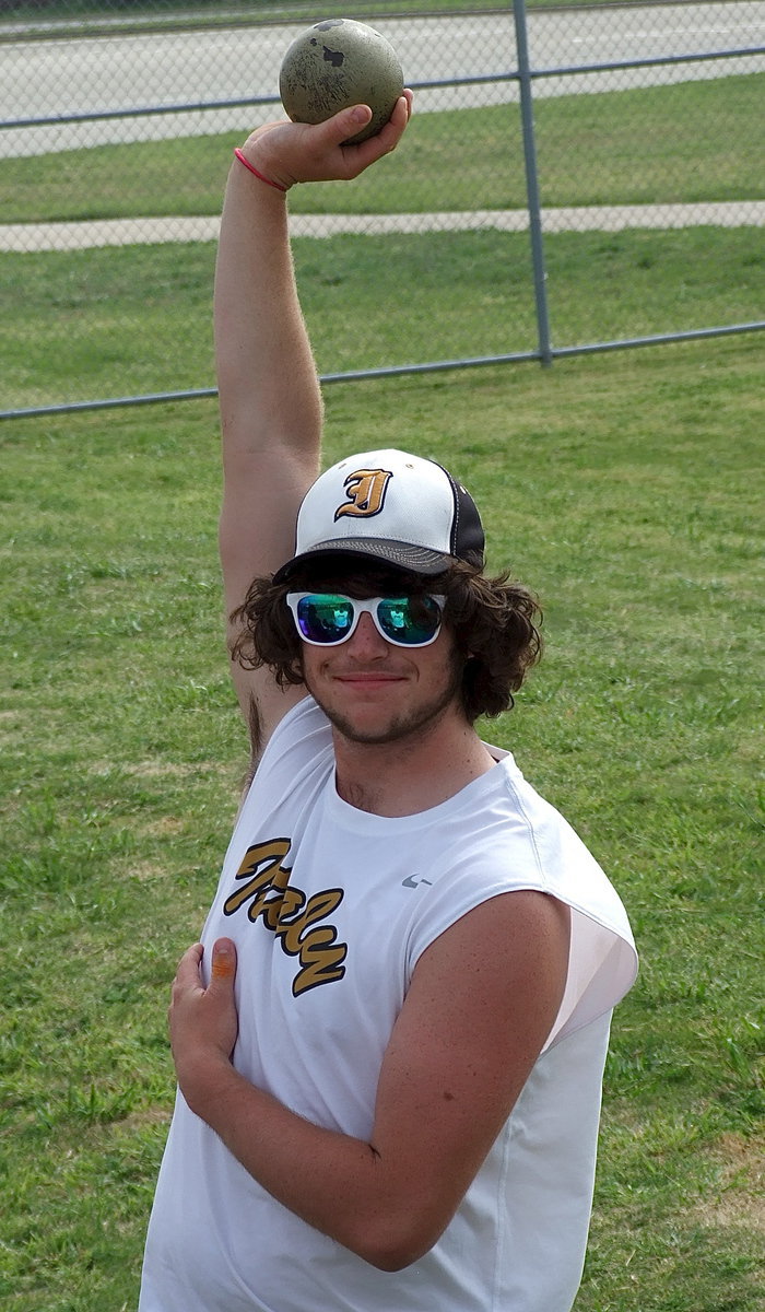 Image: Kyle Fortenberry stretches before competing in the shot put.