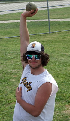 Image: Kyle Fortenberry stretches before competing in the shot put.
