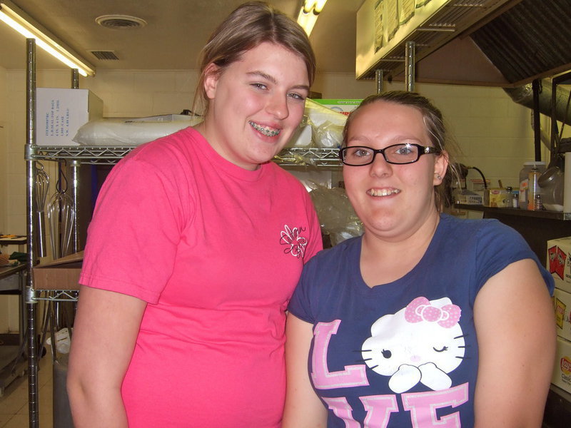 Image: Jordan Poarch (8th grade) and Katie Glenn (8th grade) are both in the National Jr. Honor Society and were happy to serve everyone a good hotdog dinner.