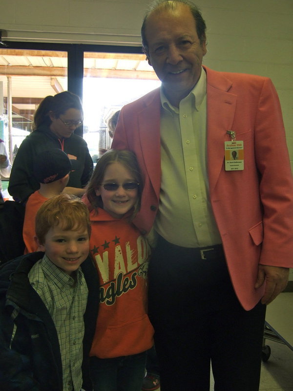 Image: Kaden Houbek (Kindergarten) and  Destini Stroud (2nd grade) stopped to give Dr. DelBosque a hug.