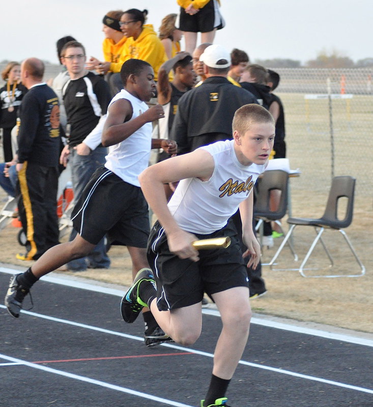 Image: Italy 7th grader Kendrick Norwood passes the baton to relay teammate Clay Riddle.