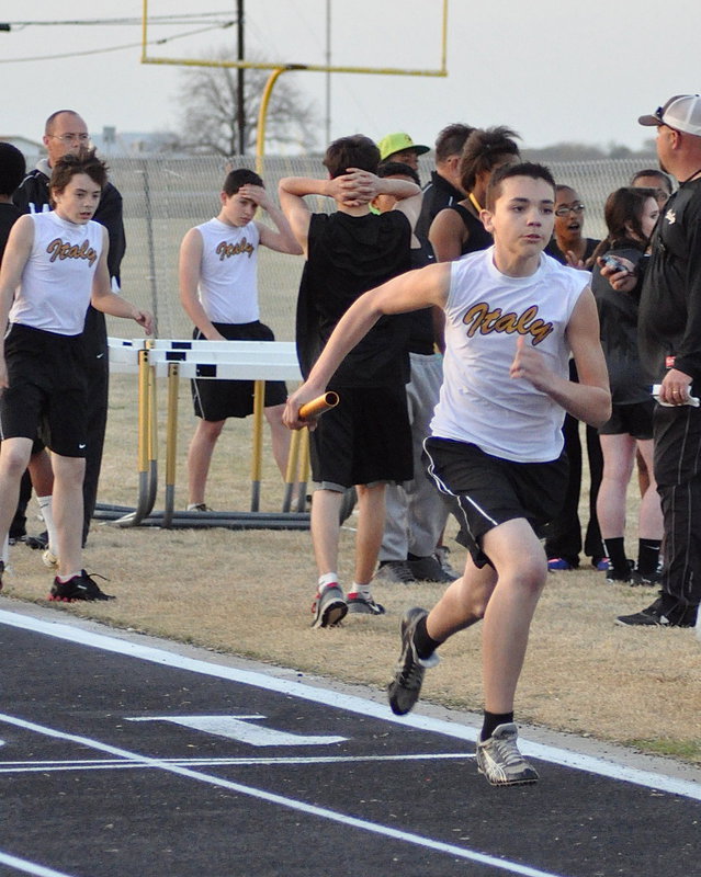 Image: Dylan McCasland passes the baton to Blake Brewer who helps Italy’s 8th grade earn a 2nd place finish in the mile relay.